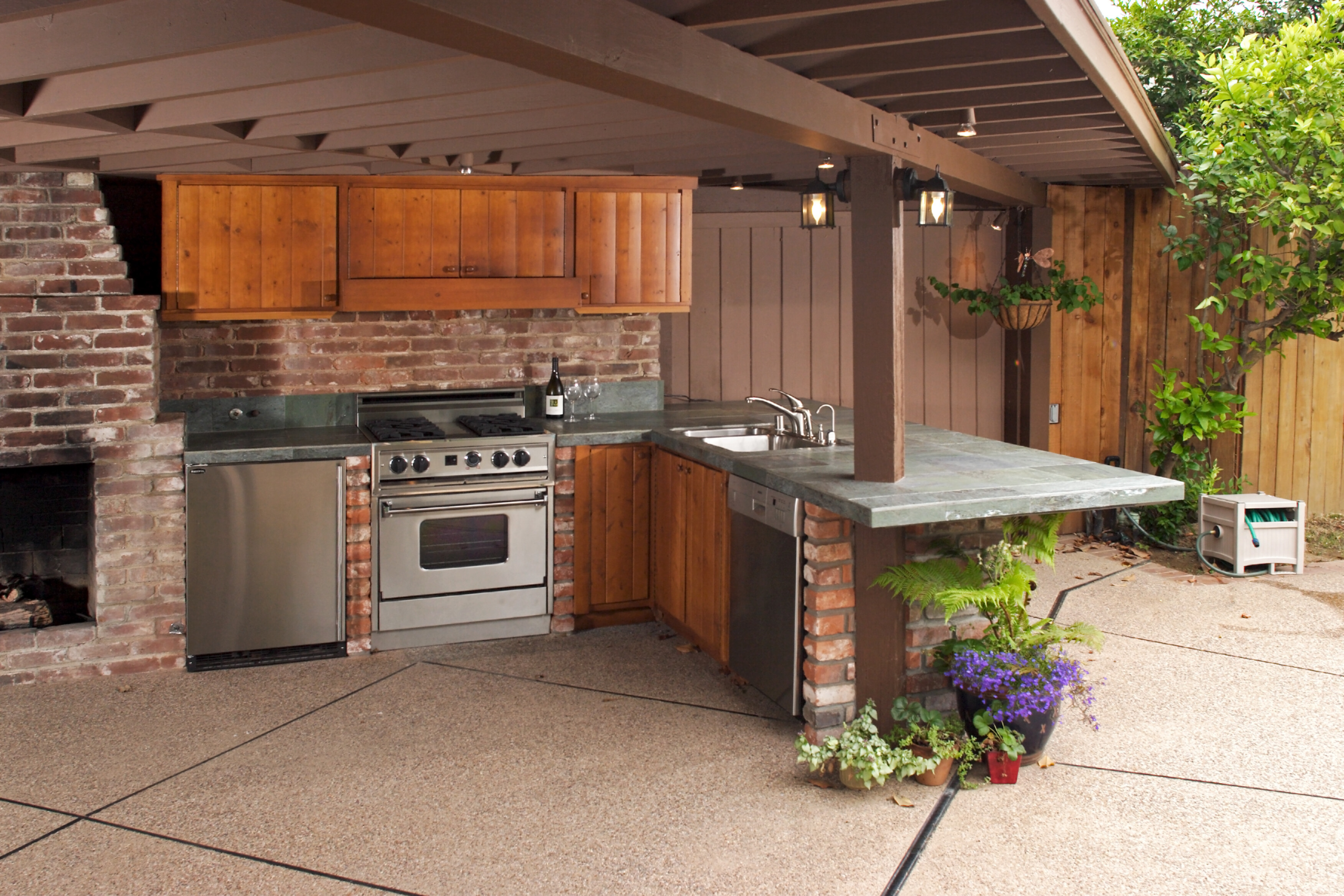 Modern outdoor kitchen with smart LED lighting and app-controlled pool automation installed by Aqualis Pools in Georgia