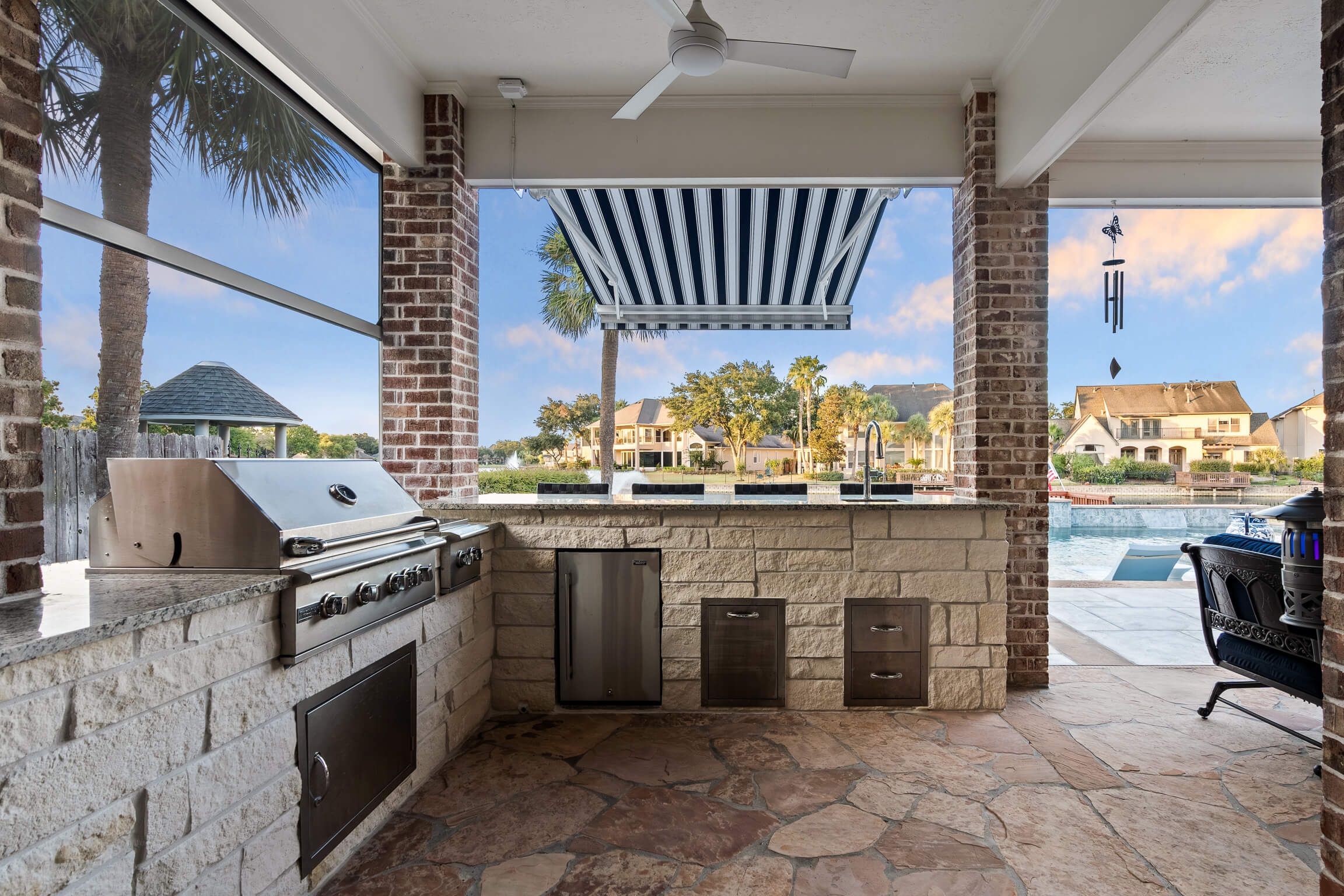 Steel-framed outdoor kitchen substructure with cement board and drainage before stone veneer, built by Aqualis Pools in Georgia