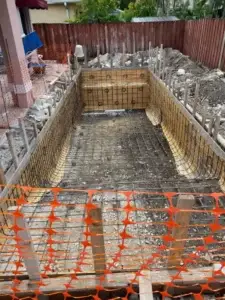 In-progress swimming pool construction with rebar and wooden forms